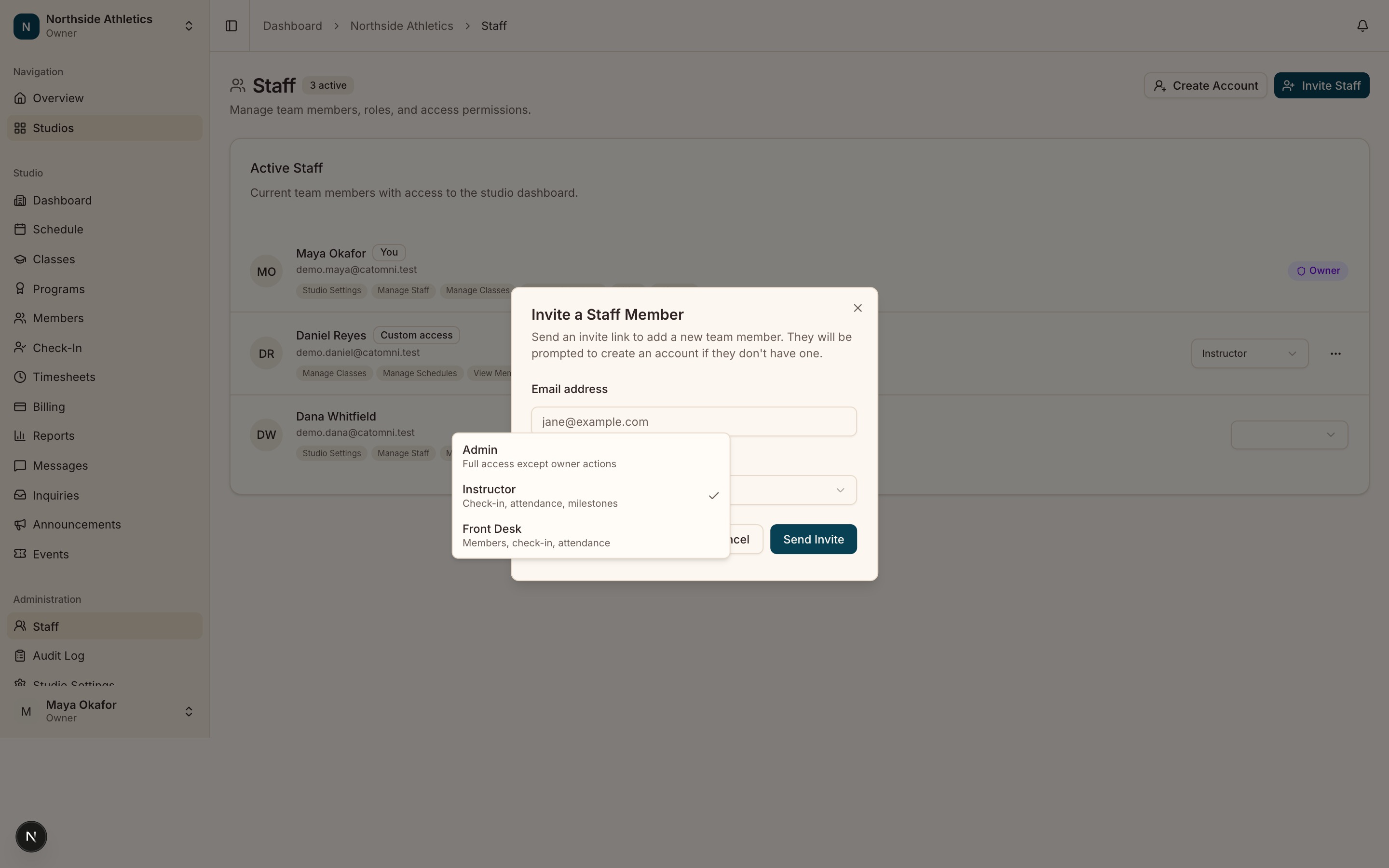 The Invite Staff dialog open over the staff directory, showing the email field and the role picker expanded to its four options.